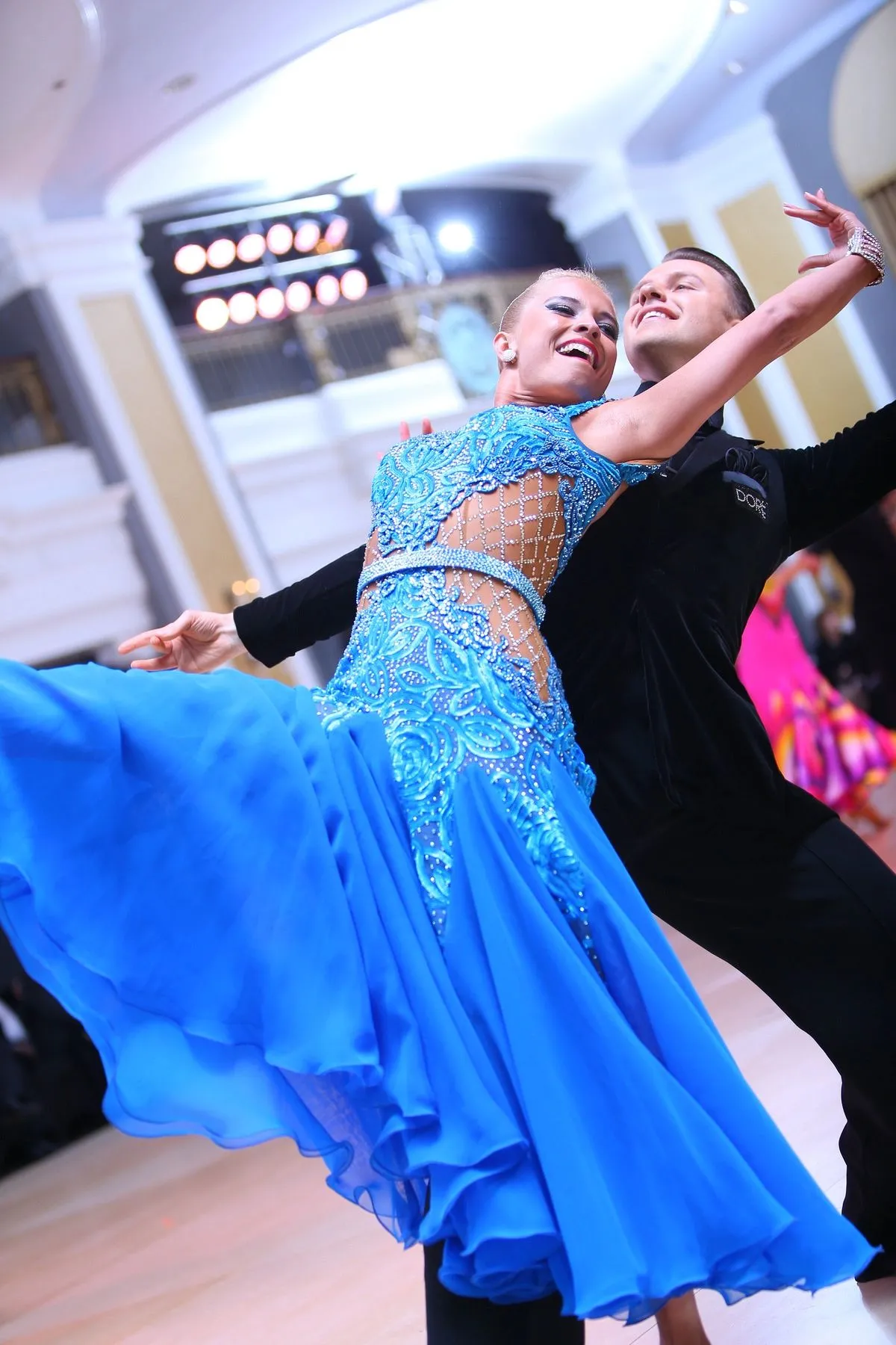 Slawek Roszak and Denise Sobiewski dancing a ballroom standard routine, Denise in a flowing blue gown